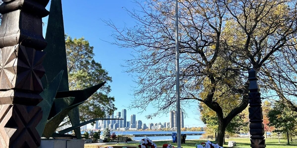 Hungarian national flag displayed with wreaths of remembrance at Budapest Park, Toronto, honoring the heroes of the 1956 Hungarian Revolution.