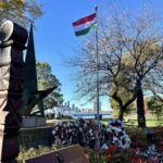 Hungarian national flag displayed with wreaths of remembrance at Budapest Park, Toronto, honoring the heroes of the 1956 Hungarian Revolution.